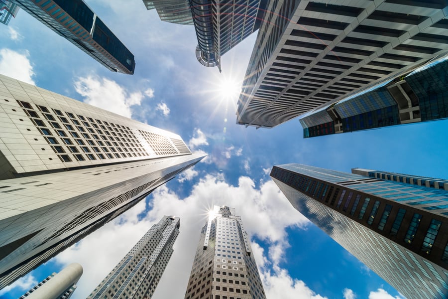 skyscraper-tower-buildings-in-business-district-singapore-city-cloud-and-sun-flares-on-sunny-day-sky_t20_Jole79